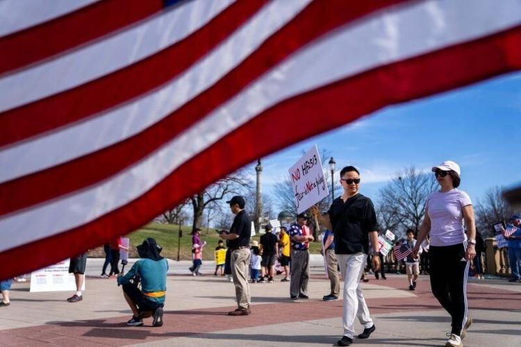 Nearly 150 gather on the steps of the Iowa State Capitol to rally against HF 2513, a bill that would prohibit Iowa Universities and Community Colleges from hiring H-1B visa holders from countries designated as foreign adversaries, on March 21, 2026, in ...