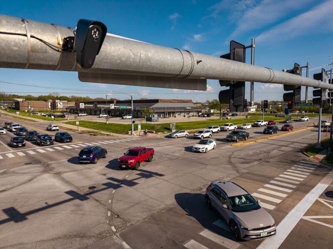 A Flock license plate camera is mounted to the traffic signal at the intersection of University Ave. and 73rd Street, April 21, 2026, in Windsor Heights.
