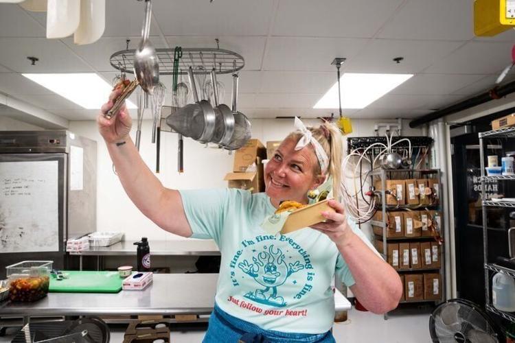 Sarah Strong-Tuttle takes a photo with the $99 caviar chicken nuggets from JR’s SouthPork Ranch on July 16, 2026, at the Iowa State Fairgrounds.