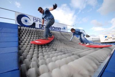 Riders demonstrate BrushBoarding on a Brush Ramp. The activity provides waterless surfing for riders, and one of the devices has been installed at the MidAmerican Energy Co. RecPlex in West Des Moines.