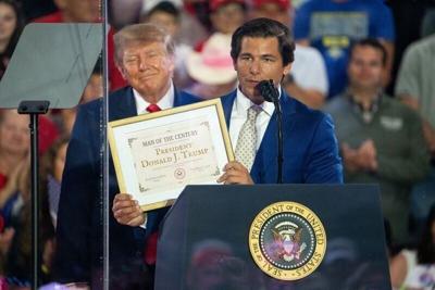 Joe Mitchell, candidate for Iowa’s 2nd Congressional District, awards President Trump the Man of the Century award while at a rally in Iowa on Oct. 22, 2026, in Sioux City.