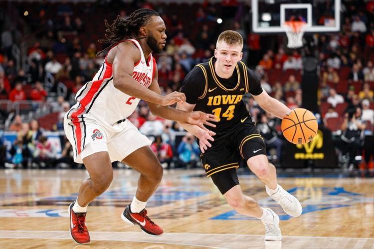 Mar 12, 2026; Chicago, IL, USA; Iowa Hawkeyes guard Bennett Stirtz (14) drives to the basket against Ohio State Buckeyes guard Bruce Thornton (2) during the first half at United Center. Mandatory Credit: Kamil Krzaczynski-Imagn Images