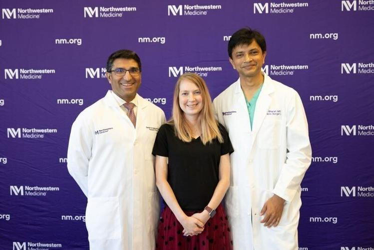Elizabeth Wehrle stands with Dr. Ankit Bharat and Dr. Satish Nadig, who helped perform her quadruple organ transplant surgery.