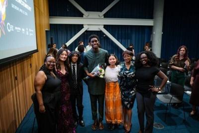 National Youth Poet Laureate Daniel Umemezie (center) of Cedar Falls poses for a picture after winning the title on April 25, 2026.