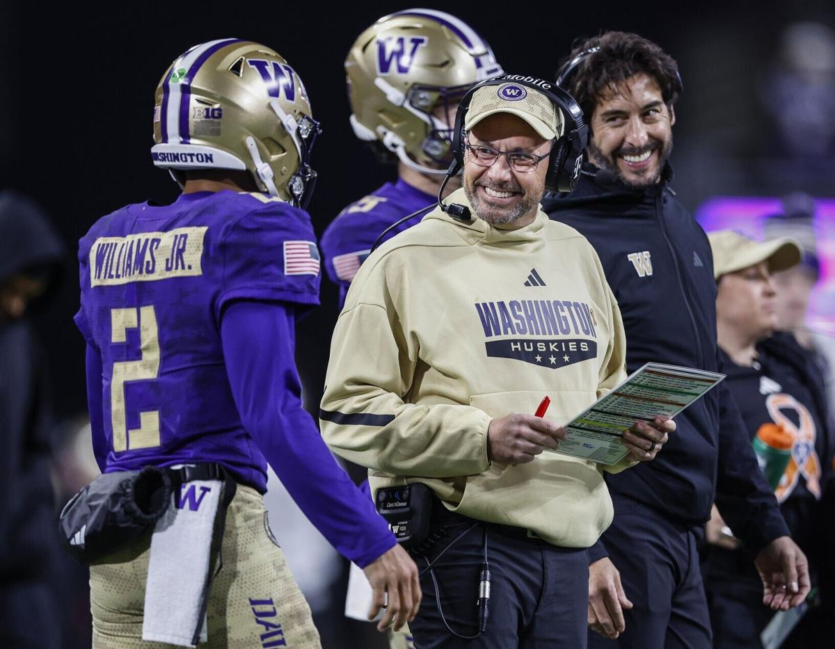 Washington head coach Jedd Fisch smiles at quarterback Demond Williams Jr. as the Huskies get inside the Purdue 5- yard line late in the second quarter at Husky Stadium on Saturday, Nov. 15, 2025, in Seattle.