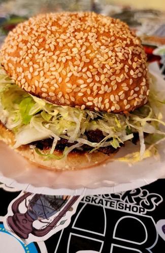 The Dream Burger at There, There has two grass-fed beef patties, USA cheese, mayo, patty sauce, onion jam and "shredduce" on a griddled sesame bun.