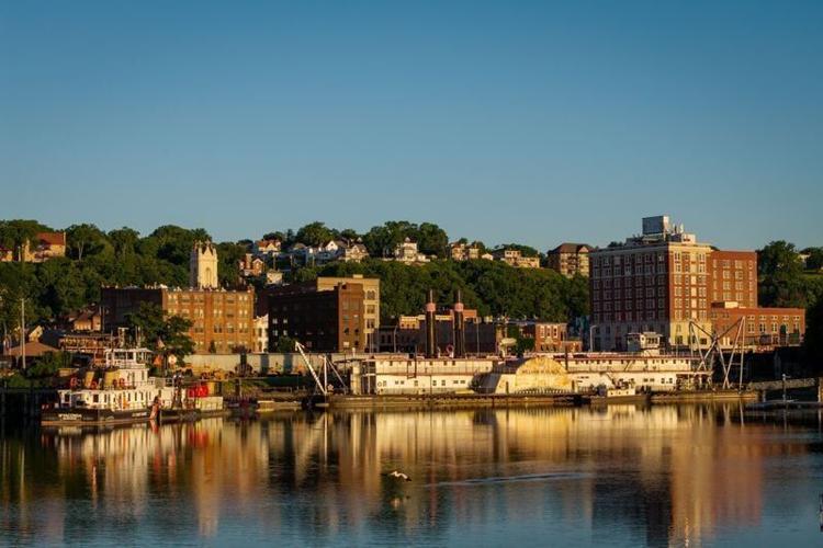 An Egret takes flight in front of the William M. Black, a historic, 20th-century steamboat permanently moored in the Dubuque harbor, June 15, 2026.