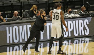 Becky Hammon, assistant coach of the San Antonio Spurs, talks with DeMar DeRozan at AT&T Center on December 30, 2020 in San Antonio, Texas.
