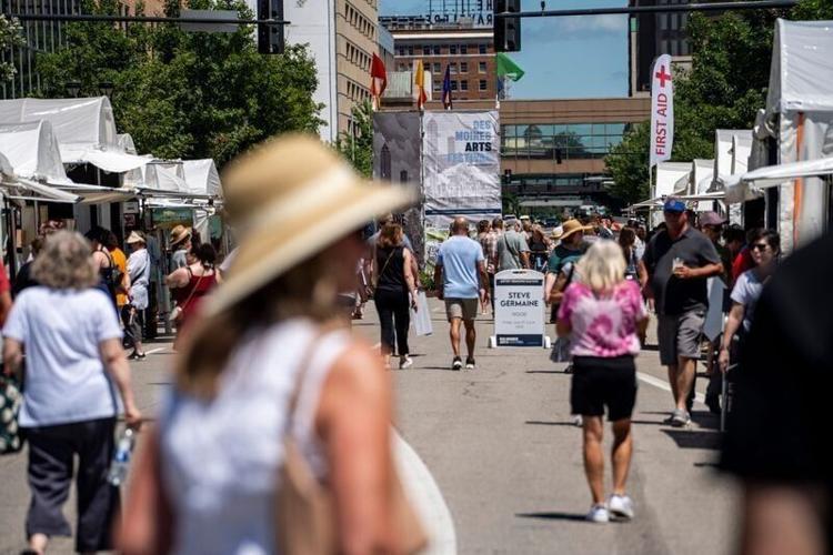 Eventgoers walk down Grand Avenue at the annual Des Moines Arts Festival on June 27, 2025, in downtown Des Moines.