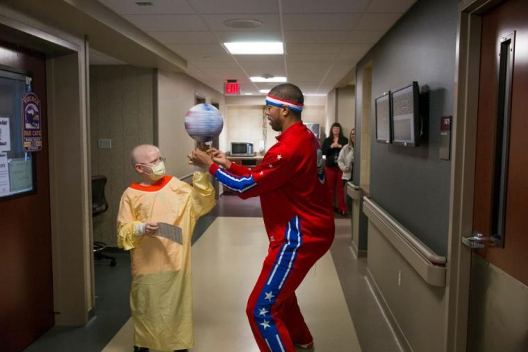 Harlem Globetrotter dribbles across the Bob Kerry Pedestiran Bridge for grand arrival into Omaha