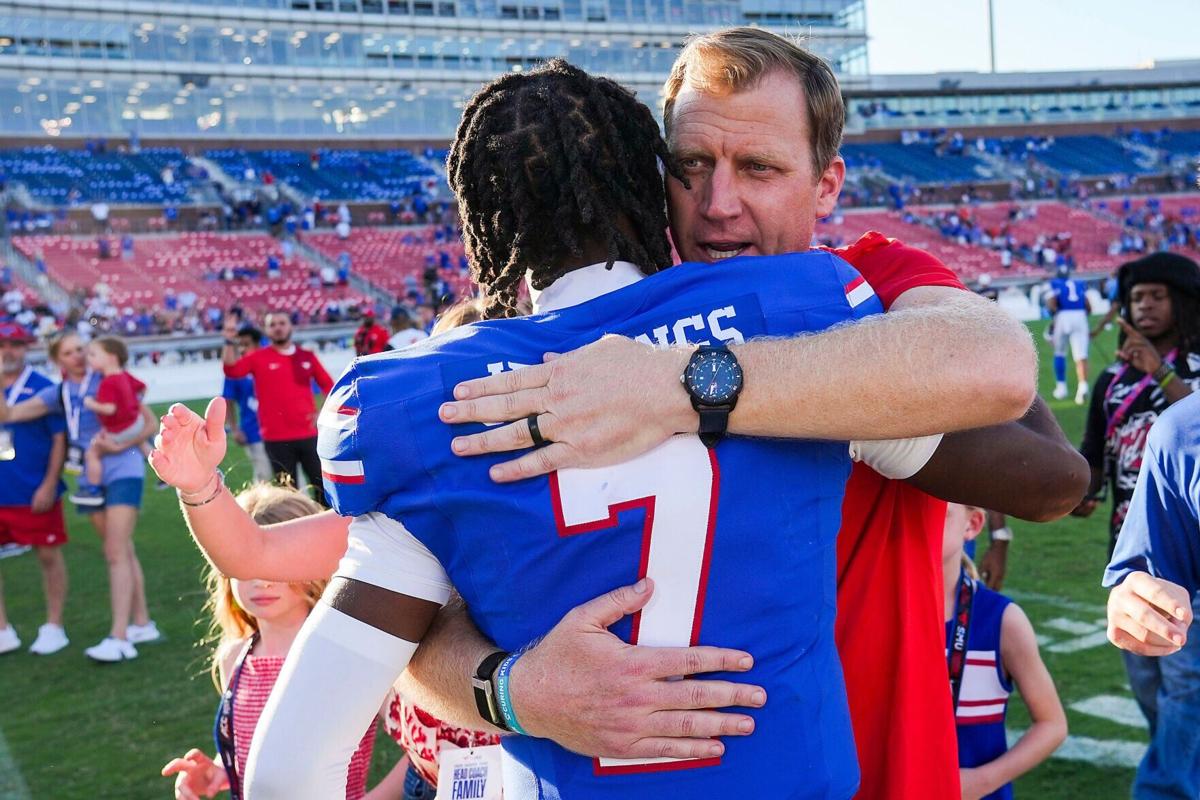 SMU head coach Rhett Lashlee hugs quarterback Kevin Jennings after the Mustangs' 31-18 victory over Syracuse in an NCAA football game on Saturday, Oct. 4, 2025, in Dallas.