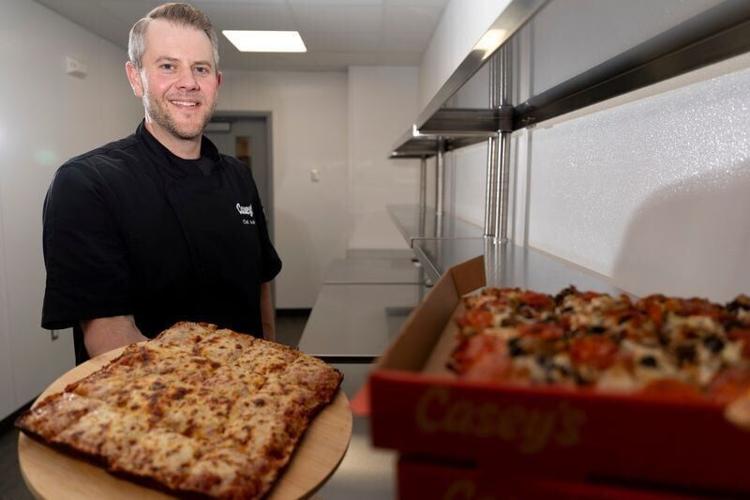 Andrew Kintigh, Casey’s executive chef, is pictured with the company’s new pan pizzas Oct. 22, 2026 in Ankeny, Iowa.