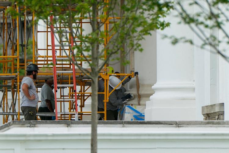 Crews work on North Portico columns at the White House in Washington