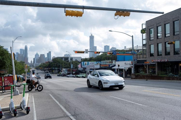 FILE PHOTO: A Tesla robotaxi drives in Austin, Texas