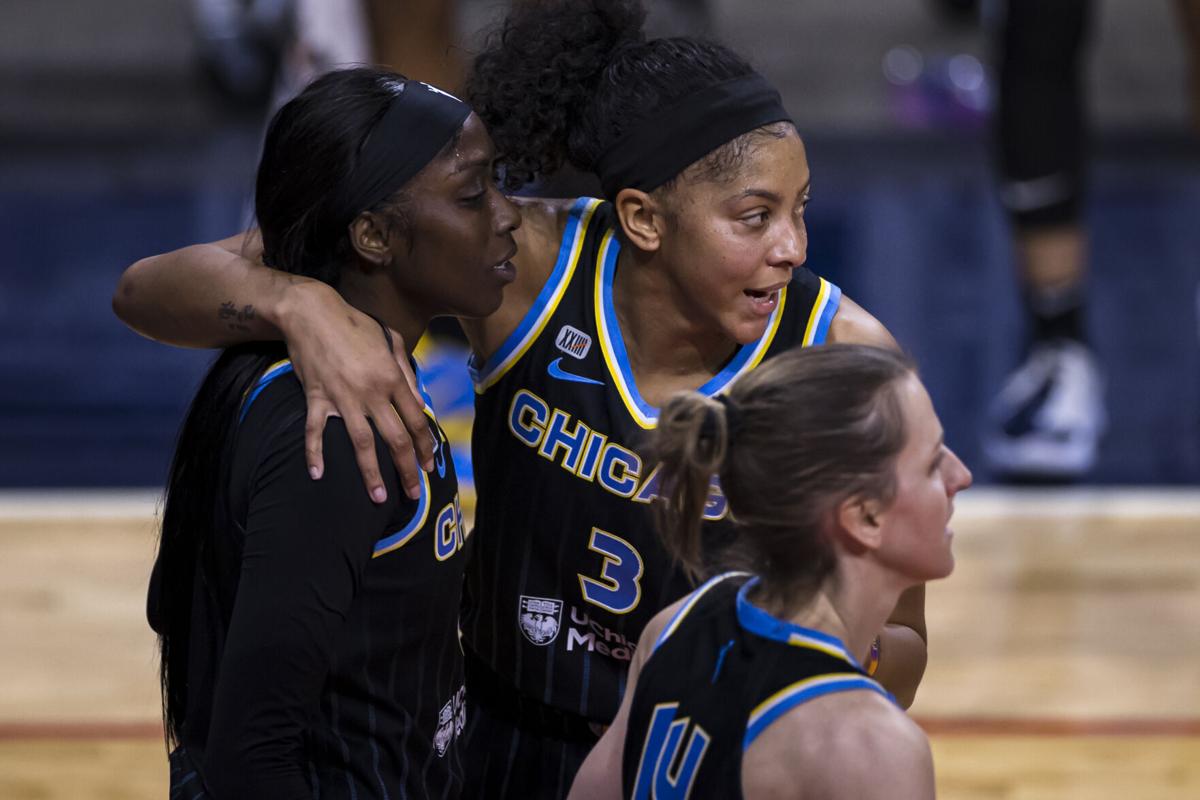 Candace Parker #3 of the Chicago Sky huddles with teammates Kahleah Copper #2 and Allie Quigley #14 during the first half of the game against the Washington Mystics at Entertainment and Sports Arena on May 15, 2021 in Washington, D.C..
