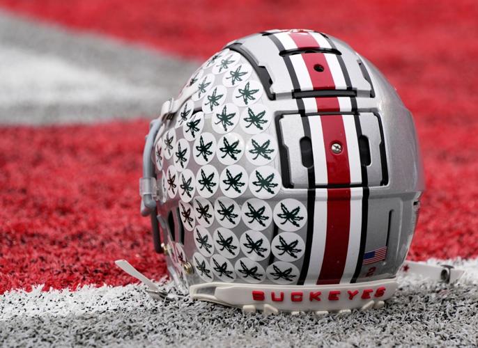 Oct. 1, 2022; Columbus, Ohio, USA; A stick-ladden Ohio State Buckeyes helmet sits on the turf during warmups before Saturday's game against the Rutgers Scarlet Knights in Columbus. Mandatory Credit: Barbara Perenic/Columbus Dispatch

Sports Ohio State Rutg