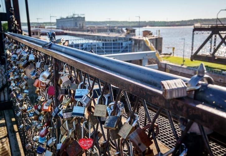 Love locks symbolizing eternal bonds are found on the Old Keokuk-Hamilton Mississippi River Bridge Observation Deck, June 12, 2026, in Keokuk. Couples attach locks to the deck's railing overlooking the river and Lock and Dam No. 19.