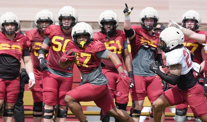 Iowa State running back Jayden Jackson (47) runs with the ball around defensive back Xavier Martinez (22) during Spring football