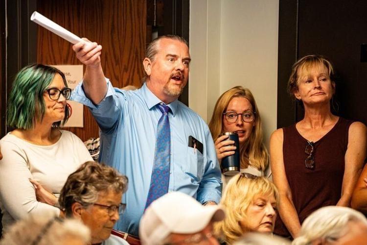 Madison County Attorney Stephen Swanson speaks from the back of a crowded room during a Madison County Board of Supervisors meeting on July 22, 2025, at the Madison County Annex in Winterset, Iowa.