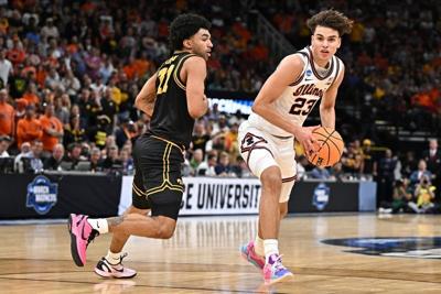 Mar 28, 2026; Houston, TX, USA; Illinois Fighting Illini guard Keaton Wagler (23) controls the ball against Iowa Hawkeyes guard Kael Combs (11) in the second half during an Elite Eight game of the South Regional of the men's 2026 NCAA Tournament at Toyo...