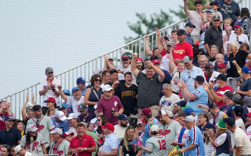 Fans celebrate after catching a ball during a baseball game between the Philadelphia Phillies and the Minnesota Twins at the