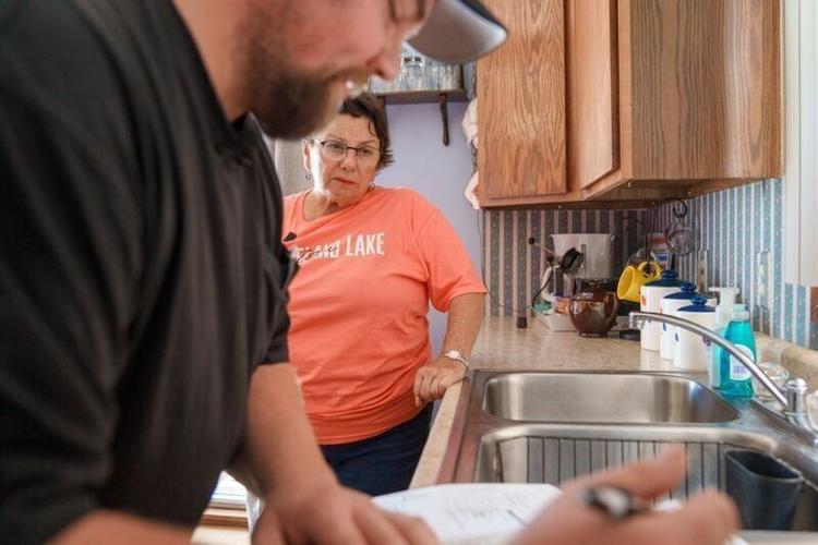 Ben Huntley, environmental health coordinator for Emmet and Palo Alto counties, performs a water test with Maureen Reeves Horsley, a nurse practitioner and Palo Alto County resident, on Wednesday, July 29, 2026.