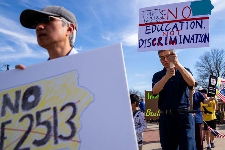 From left: Nian Nian of Iowa City and George Cai of Johnston rally against HF 2513, a bill barring universities and community colleges from hiring H-1B visa holders from countries designated as foreign adversaries, on March 21, 2026, at the Iowa State C...