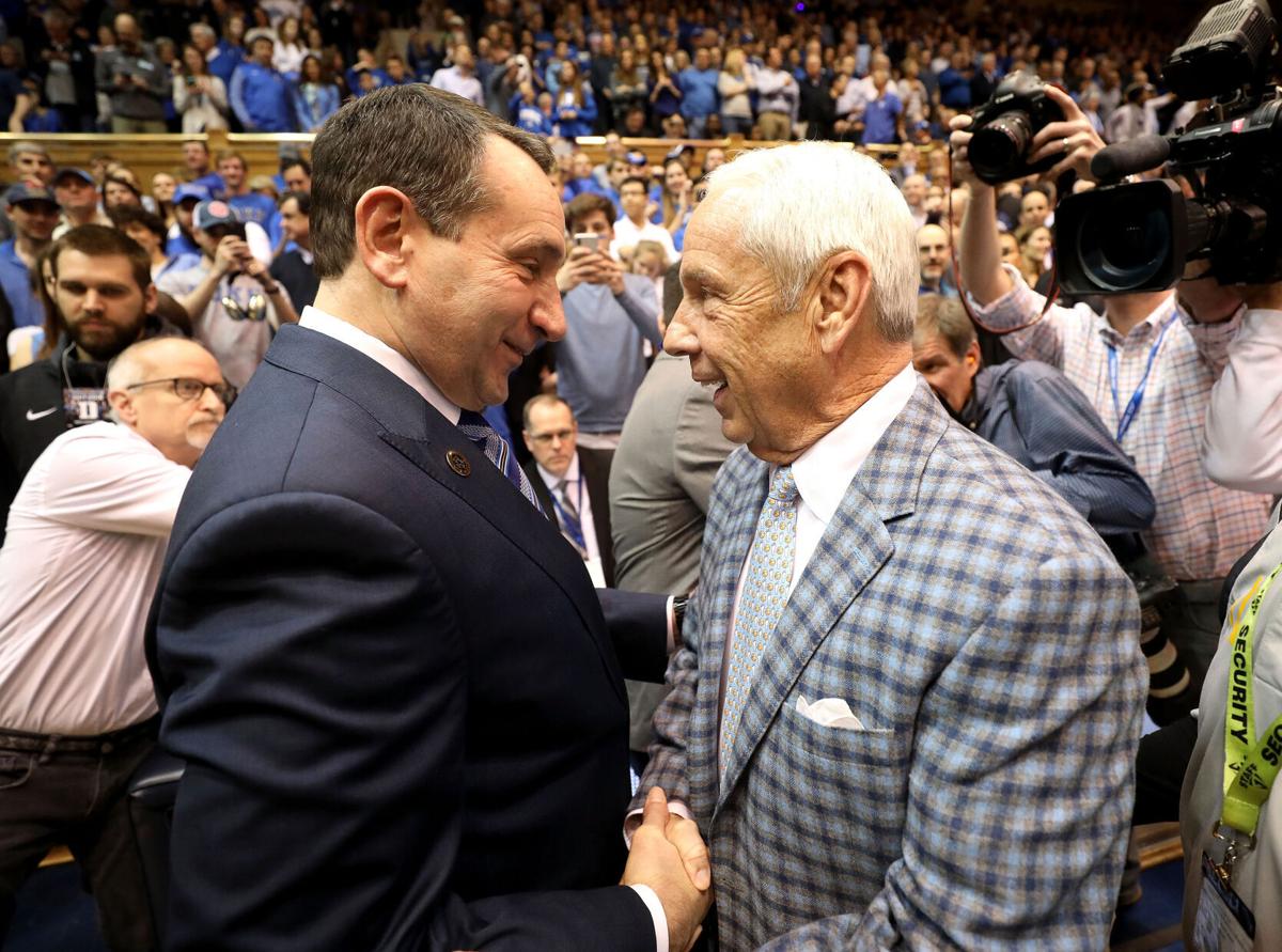 Duke head coach Mike Krzyzewski, left, talks to North Carolina head coach Roy Williams before a 2018 game at Cameron Indoor Stadium in Durham, North Carolina.