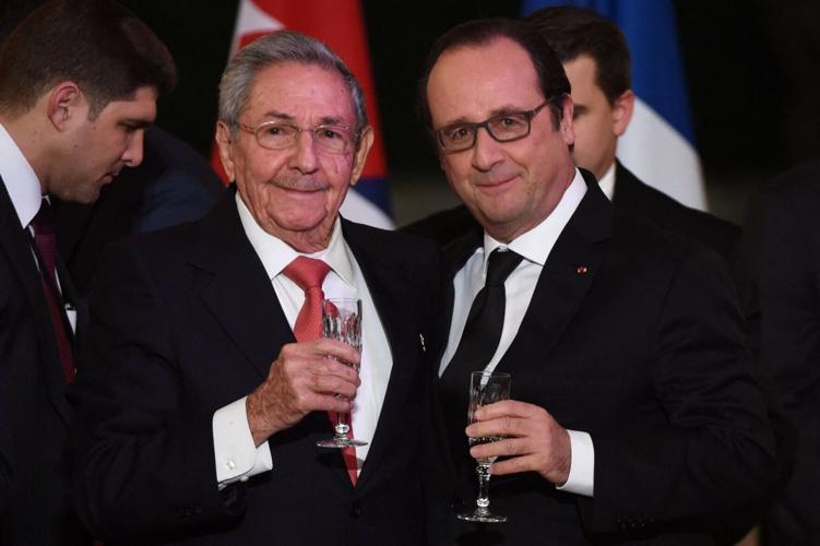 FILE PHOTO: French President Francois Hollande and Cuba's President Raul Castro raise a glass to make a toast during a State dinner at the Elysee Palace in Paris