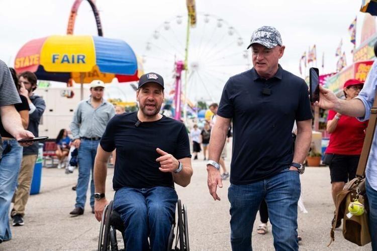 U.S. Sen. Mark Kelly, D-AZ, tours the Iowa State Fairgrounds with Democratic U.S. Senate candidate Josh Turek on Aug. 14, 2026.