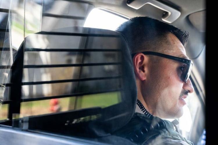 Deputy TJ Merrifield, of the Polk County Sheriff’s Office, looks down the street as he patrols downtown Mitchellville on April 10, 2026.