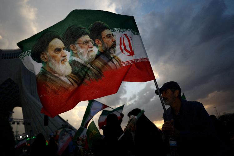 FILE PHOTO: A man holds a flag during a rally in Tehran