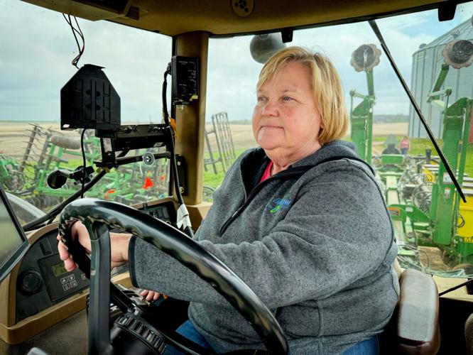 April Hemmes at the wheel of her tractor on her farm near Hampton.