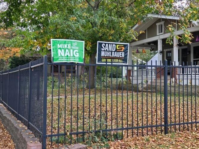 A home in Des Moines’ Drake neighborhood displays campaign signs for Democratic candidate for governor Rob Sand and Republican agriculture secretary Mike Naig’s reelection on Tuesday, Oct. 27, 2026.