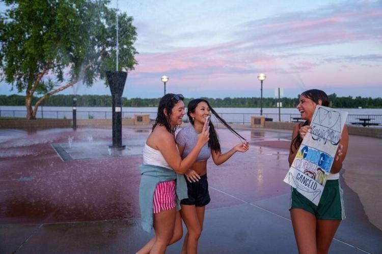 Tahlor Prado films a TikTok video for her friend Sophie Jo in the fountain at Riverside Park, June 15, 2026, in Muscatine, Iowa.