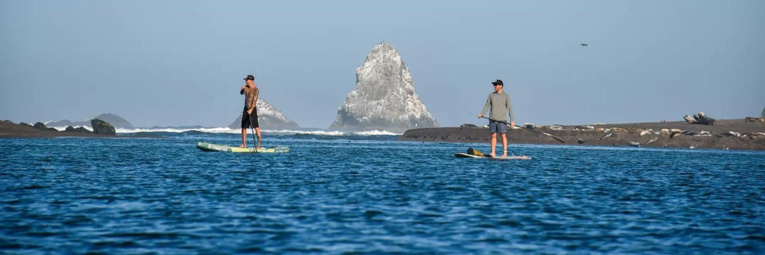Stand-up paddle-boarders are common at the Russian River estuary, next to Jenner on the Sonoma County coast.