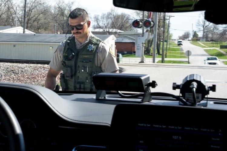 Deputy TJ Merrifield walks back to his vehicle after making a traffic stop on April 10, 2026, in Mitchellville, IA.