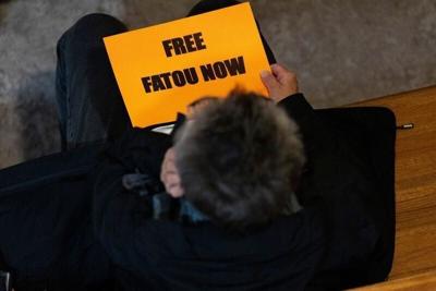 An attendee of a rally calling to free Fatou Traore from ICE detention holds a sign Sept. 30, 2026 at the First United Methodist Church in downtown Iowa City, Iowa.