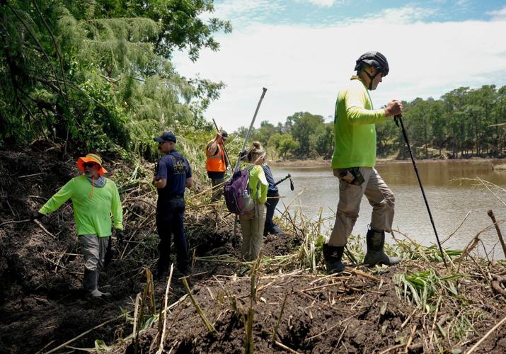 Eric Herr, a volunteer with Search and Support San Antonio, does search and rescue work on the banks of the Guadalupe River in Ingram, Tuesday, July 8, 2025, after the Fourth of July flood.