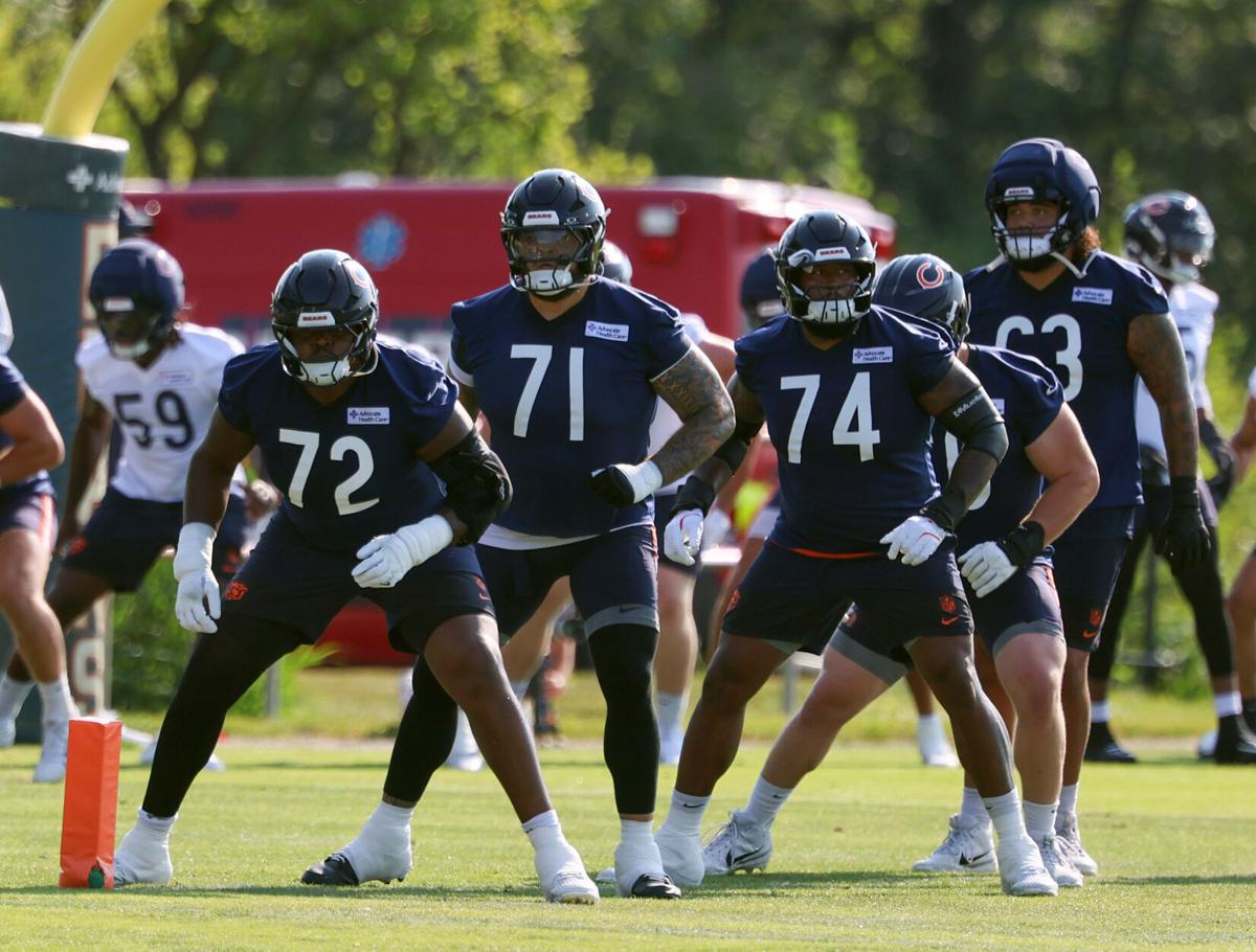 Bears offensive linemen Kiran Amegadjie (72), Jedrick Wills Jr. (71) and Jordan McFadden (74) warm up during training camp at Halas Hall on July 29, 2026, in Lake Forest.