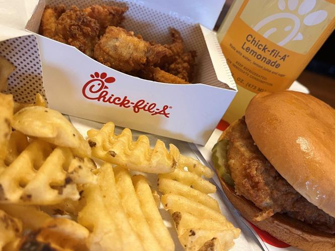 A Chick-fil-A chicken sandwich, nuggets, waffle fries and a lemonade are seen in this photograph.