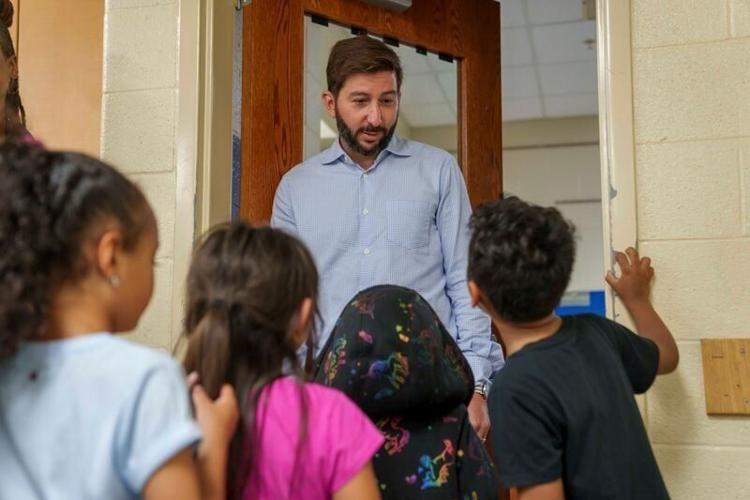 Tanner Krause works with children attending the Levitt Boys & Girls Club at Carver Elementary in Des Moines.