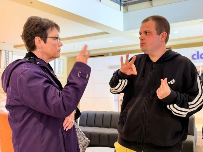 Sam Walker requests French fries from his mom, Leisa Walker, as they talk about visiting the food court at the mall on Feb. 26, 2026, in West Des Moines.