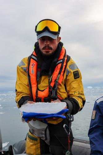 Scientist Liam Northfield describes the ecosystem to passengers on the expedition ship.