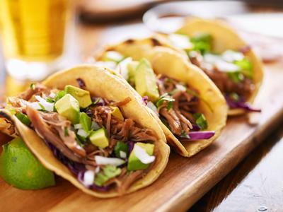 Three pork carnitas street tacos