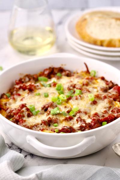 Easy Cheesy Hamburger Noodle Casserole features lean ground beef layered with rich egg noodles, topped by chopped tomatoes, green chilies and cheese.