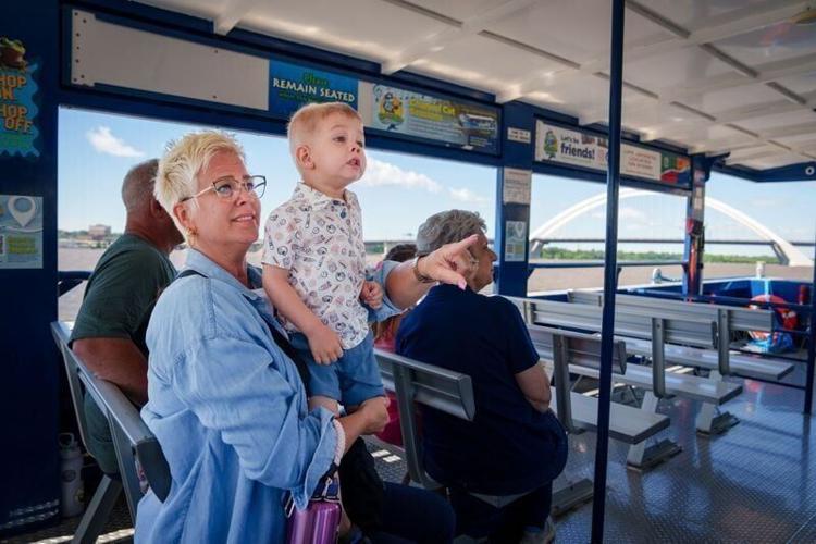 Michelle Fisher holds her nephew, Cohen Taylor, 2, as he takes his first boat ride down the Mississippi River on the Channel Cat, June 16, 2026, in Bettendorf, Iowa.