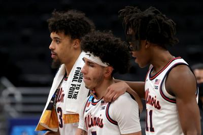 Jacob Grandison #3, Andre Curbelo #5 and Ayo Dosunmu #11 of the Illinois Fighting Illini react after being defeated by the Loyola Chicago Ramblers in the second round game of the 2021 NCAA Men's Basketball Tournament at Bankers Life Fieldhouse on March ...