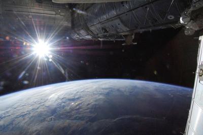 FILE PHOTO: The sun is captured over Earth's horizon by one of the Expedition 36 crew members aboard the International Space Station