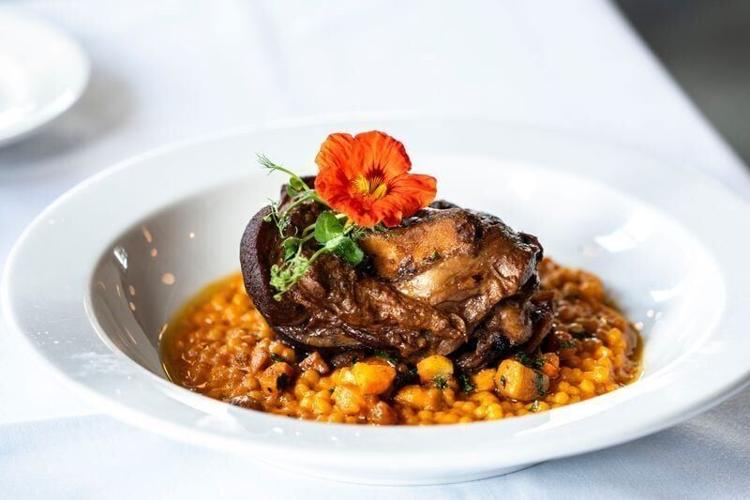 The lamb shank at HoQ restaurant features locally raised grass-fed lamb, spiced Israeli couscous, and seasonal vegetables on Thursday, April 11, 2024, in Des Moines.